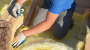 worker removing wet insulation